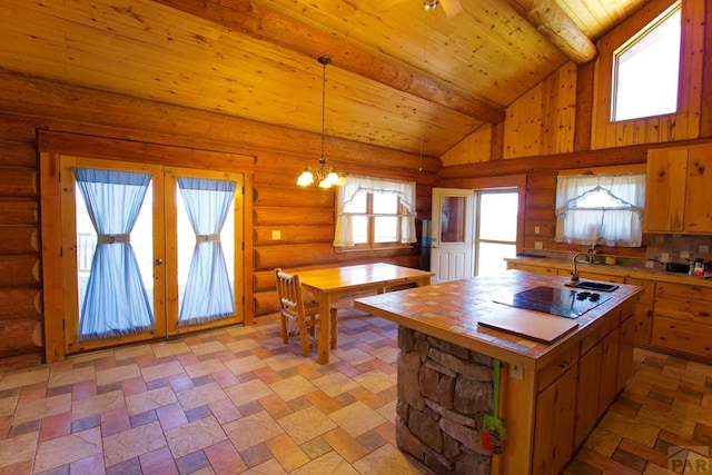 kitchen featuring a sink, black electric cooktop, french doors, vaulted ceiling with beams, and wood ceiling