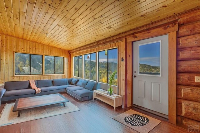 sunroom with lofted ceiling and wooden ceiling