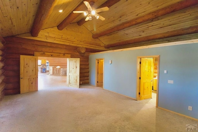 carpeted empty room featuring lofted ceiling with beams, log walls, ceiling fan, and wood ceiling