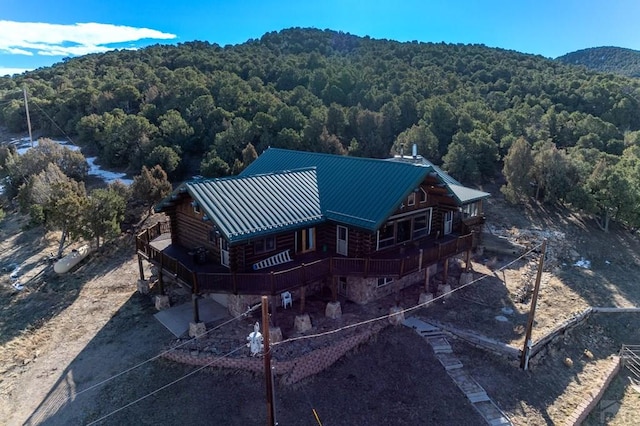 aerial view featuring a view of trees and a mountain view