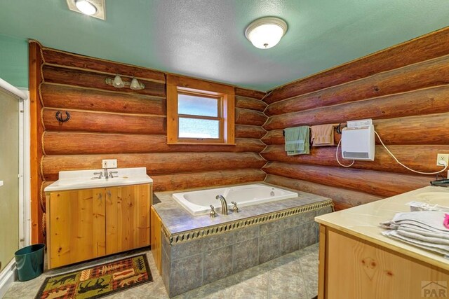 full bathroom featuring a sink, rustic walls, two vanities, and a bath