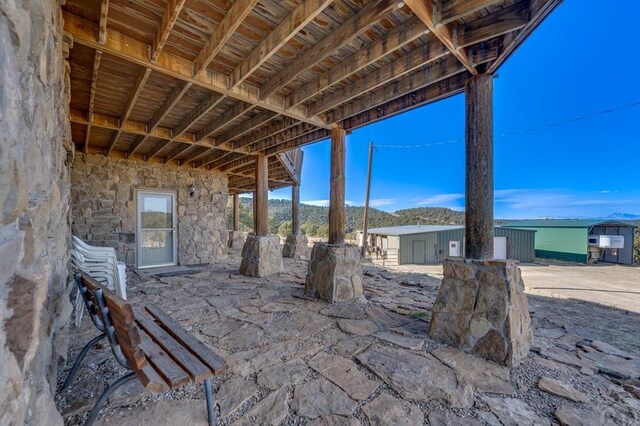 view of patio / terrace featuring a mountain view and an outdoor structure