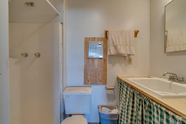 full bath with a sink, toilet, and a shower