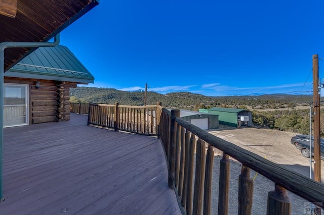 wooden deck featuring an outdoor structure and a mountain view