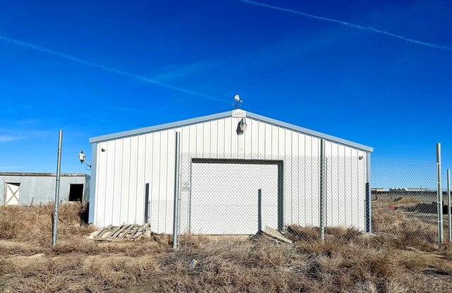 view of outbuilding with an outdoor structure and fence