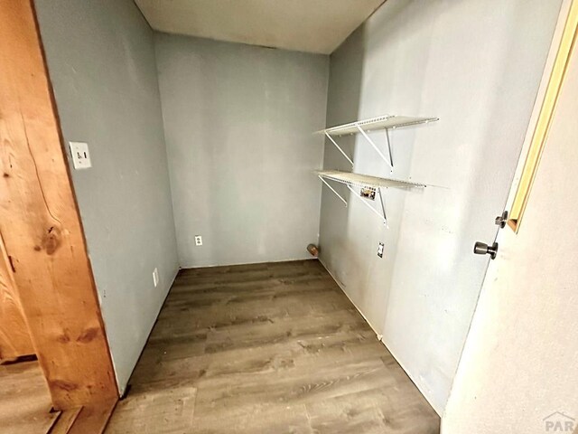 washroom featuring laundry area, wood finished floors, and hookup for a washing machine