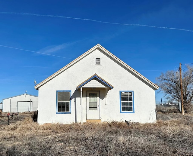 bungalow-style home featuring stucco siding