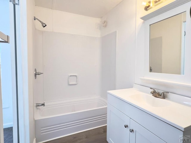 full bathroom featuring shower / tub combination, wood finished floors, and vanity