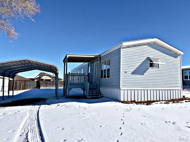 exterior space with fence and a detached carport