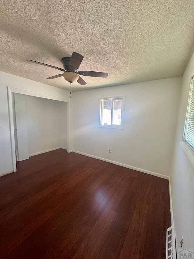 19 Cornell Cir, Pueblo, CO 81005 - spare room with dark wood-style floors, a textured ceiling, and ceiling fan