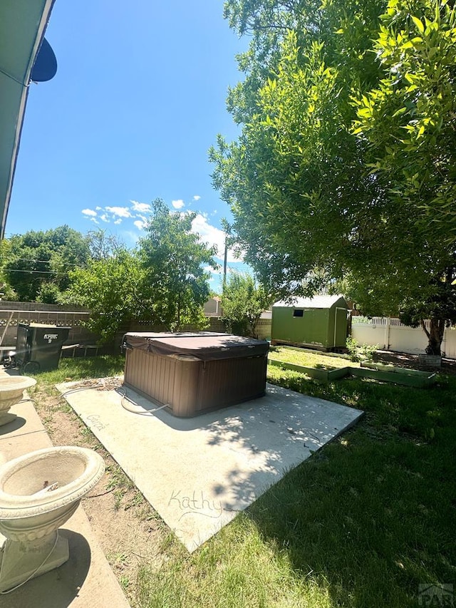 19 Cornell Cir, Pueblo, CO 81005 - fenced backyard featuring a hot tub, a storage shed, and a patio