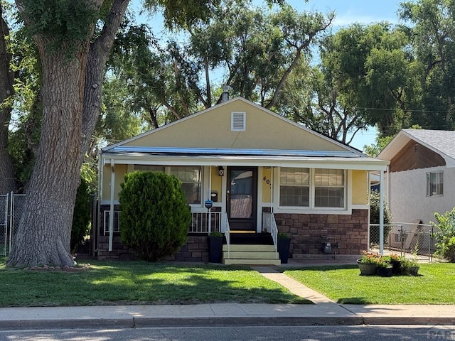 402 Alma Ave, Pueblo, CO 81004 - bungalow featuring stone siding, covered porch, and stucco siding