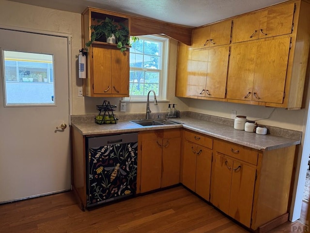 402 Alma Ave, Pueblo, CO 81004 - kitchen featuring dishwashing machine, wood finished floors, light countertops, and a textured ceiling