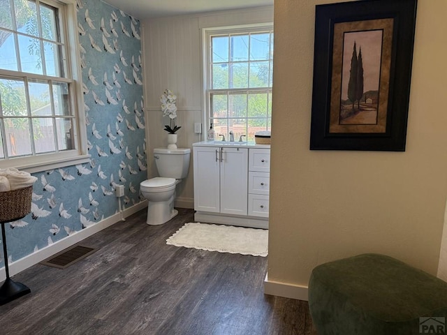 402 Alma Ave, Pueblo, CO 81004 - bathroom featuring wood finished floors, healthy amount of natural light, vanity, and wallpapered walls