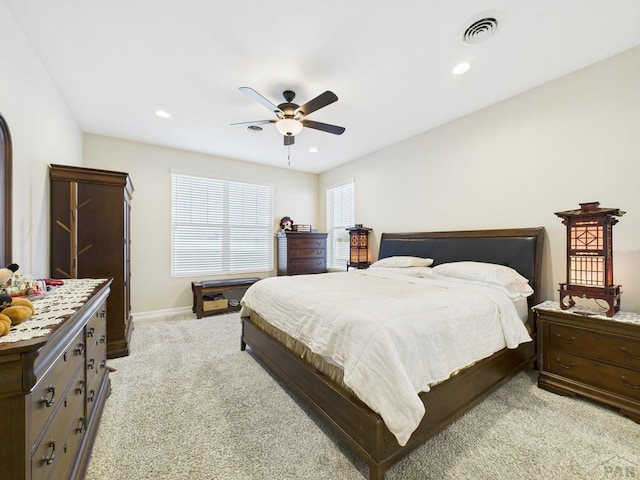 bedroom featuring light colored carpet, visible vents, and recessed lighting