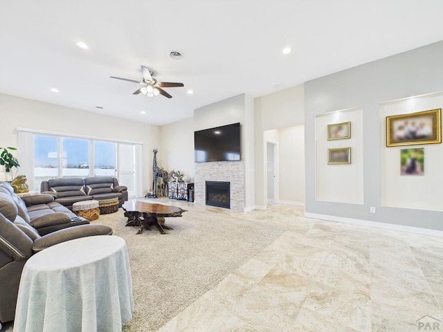 living room with recessed lighting, baseboards, visible vents, a ceiling fan, and a stone fireplace