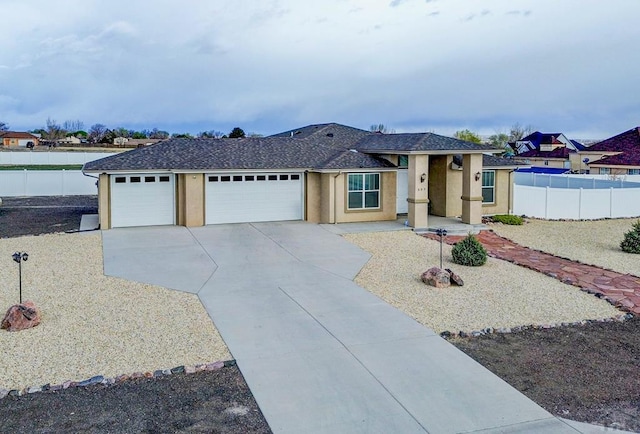 ranch-style house with a garage, concrete driveway, stucco siding, and fence