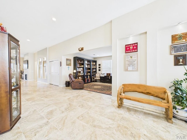 hall featuring baseboards and recessed lighting