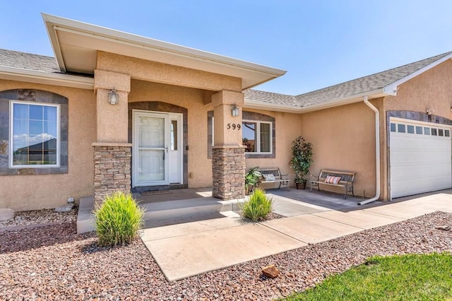 property entrance featuring a garage, a shingled roof, and stucco siding