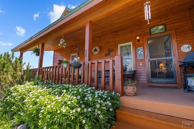 doorway to property featuring covered porch