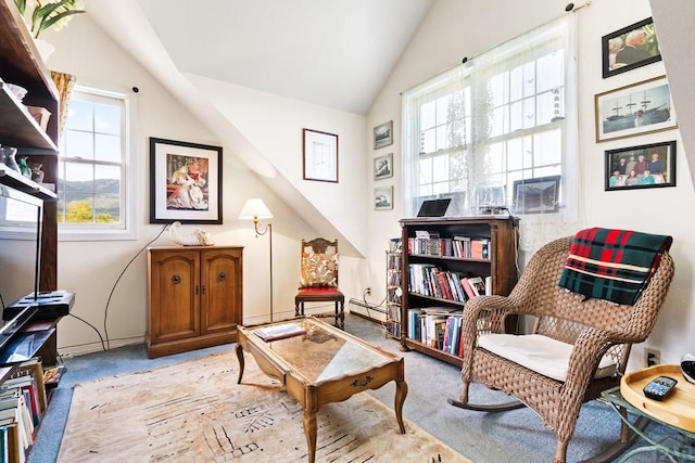 living area with lofted ceiling, plenty of natural light, and light carpet