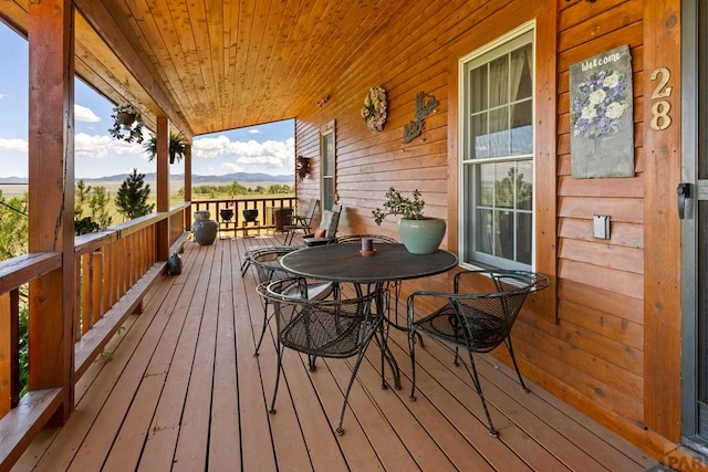 wooden deck with a porch and a mountain view