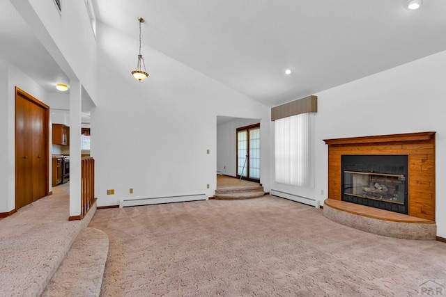 unfurnished living room with a baseboard heating unit, a glass covered fireplace, light carpet, and plenty of natural light