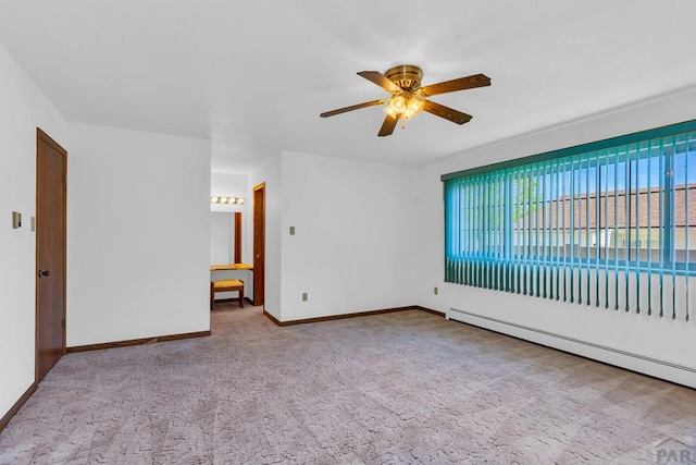 spare room with baseboards, a baseboard radiator, a ceiling fan, and light colored carpet