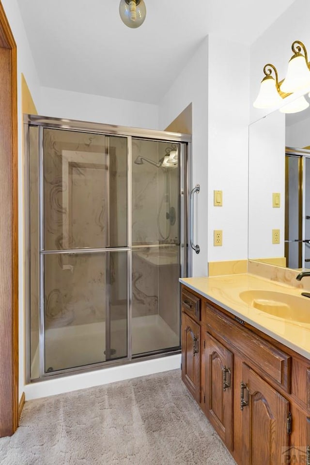 bathroom with a shower stall and vanity