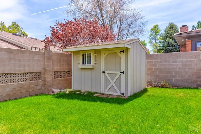 view of shed with a fenced backyard