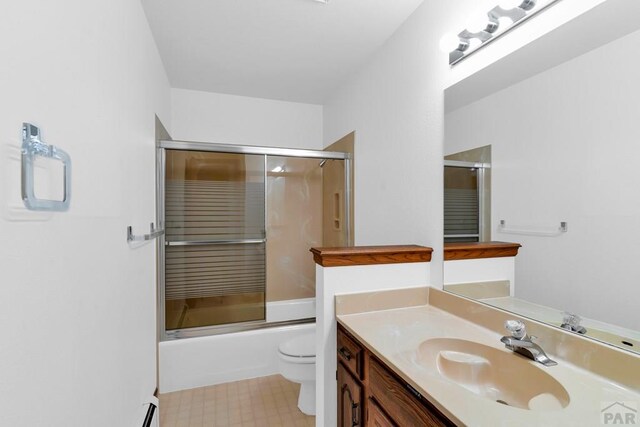 bathroom with combined bath / shower with glass door, vanity, and toilet