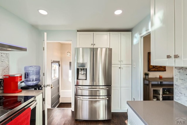 kitchen with dark wood-style floors, recessed lighting, white cabinets, and stainless steel fridge