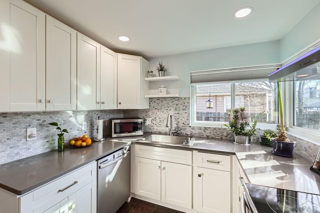 kitchen featuring a healthy amount of sunlight, open shelves, white cabinetry, and stainless steel appliances