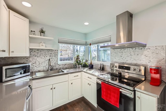 kitchen featuring stainless steel appliances, a sink, exhaust hood, white cabinets, and open shelves