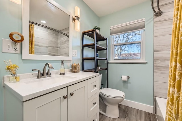 full bathroom featuring toilet, baseboards, wood finished floors, and vanity