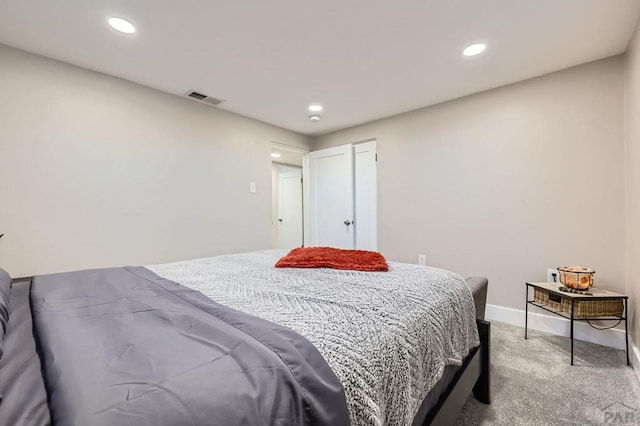 bedroom with recessed lighting, visible vents, light carpet, and baseboards