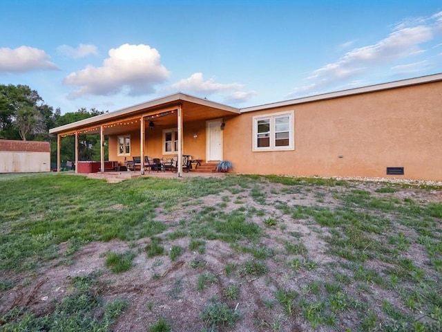 52825 E US Highway 50, Boone, CO 81025 - rear view of property with stucco siding, a patio, and a lawn