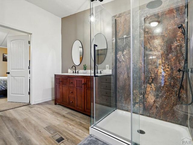 52825 E US Highway 50, Boone, CO 81025 - ensuite bathroom with double vanity, a shower stall, and wood finished floors