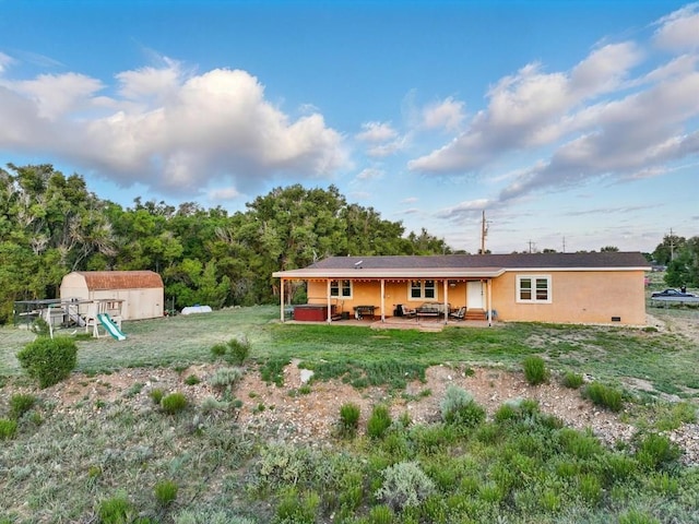 52825 E US Highway 50, Boone, CO 81025 - back of house featuring a patio, a storage shed, stucco siding, and a yard