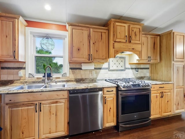 52825 E US Highway 50, Boone, CO 81025 - kitchen with appliances with stainless steel finishes, light stone counters, decorative backsplash, dark wood-type flooring, and light brown cabinetry
