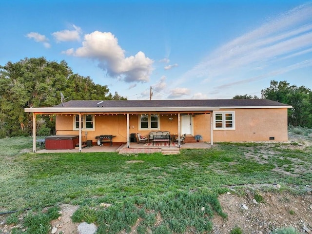 52825 E US Highway 50, Boone, CO 81025 - rear view of house with a hot tub, a patio, a yard, and stucco siding
