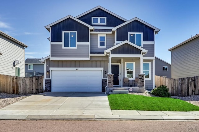 craftsman inspired home featuring covered porch, board and batten siding, and fence