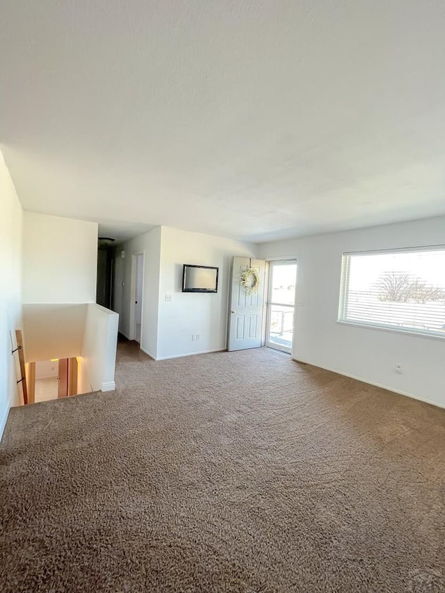 unfurnished living room featuring carpet