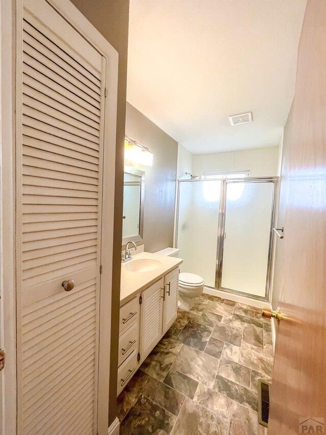 full bathroom featuring a closet, visible vents, vanity, and toilet