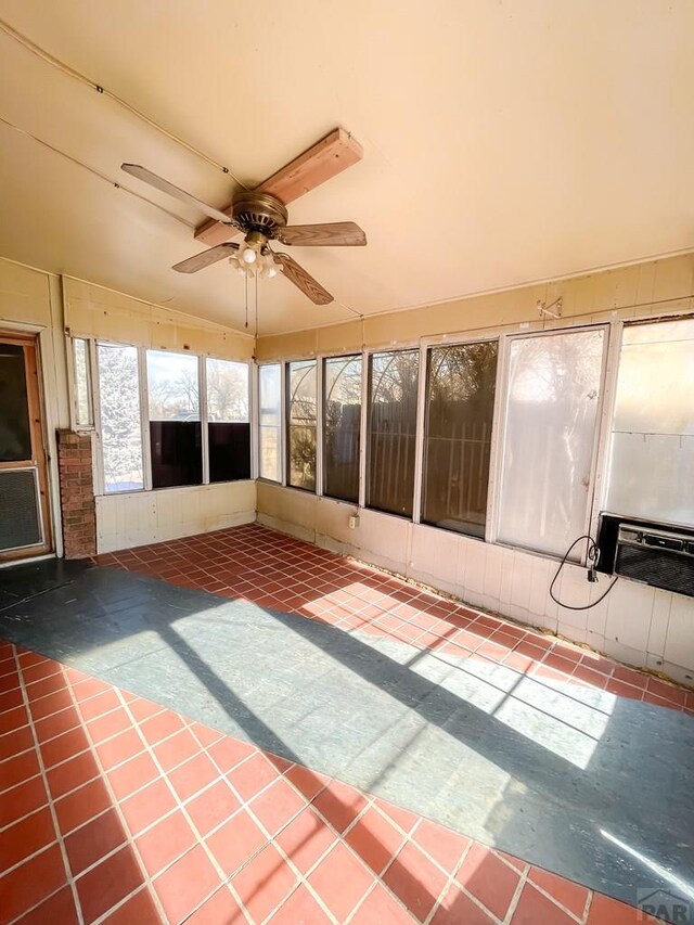 unfurnished sunroom with ceiling fan