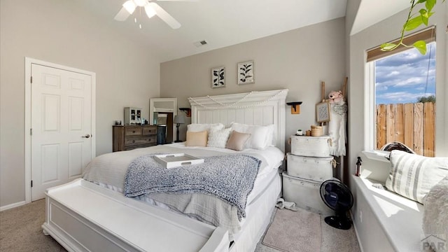 bedroom with light carpet, ceiling fan, and visible vents