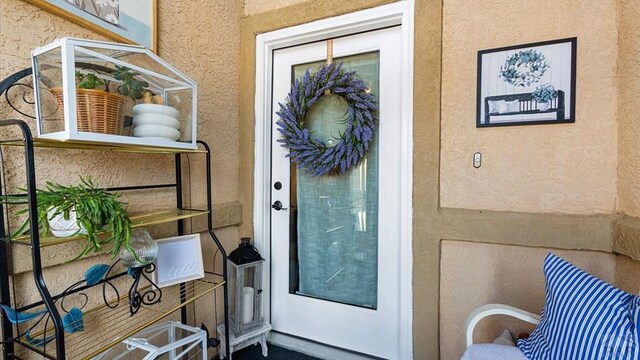 entrance to property with stucco siding