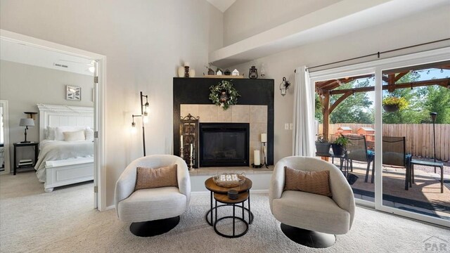 sitting room featuring carpet floors and a tile fireplace