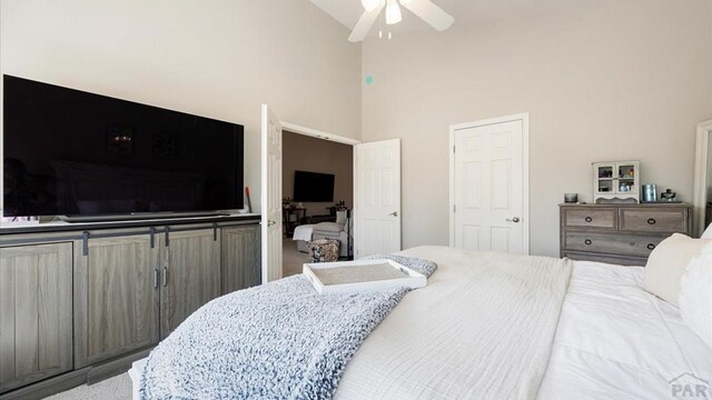 bedroom featuring a ceiling fan and high vaulted ceiling