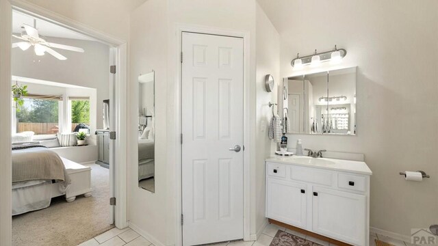 bathroom with ceiling fan, connected bathroom, and vanity